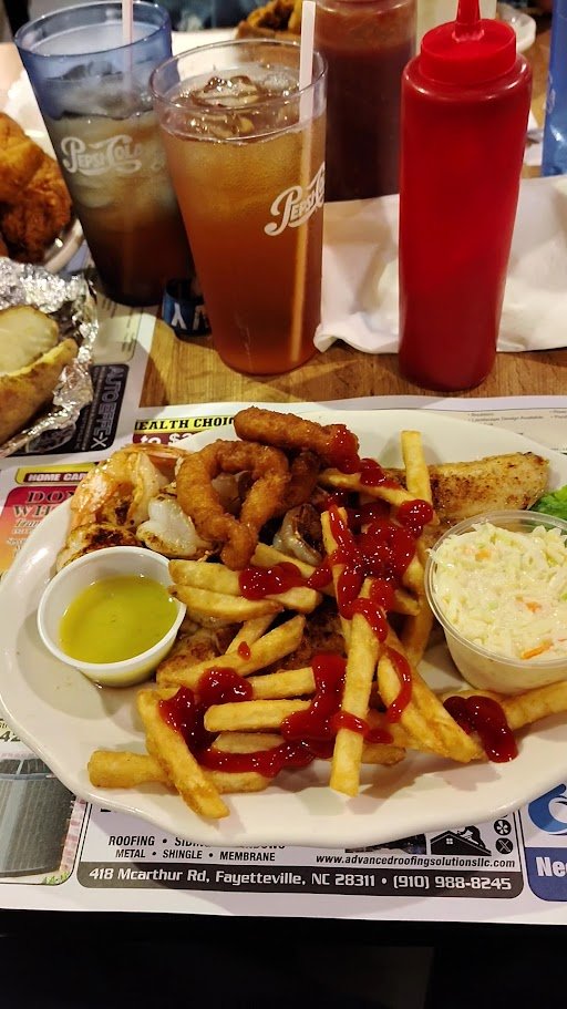 Fried flounder and onion rings on white plates.