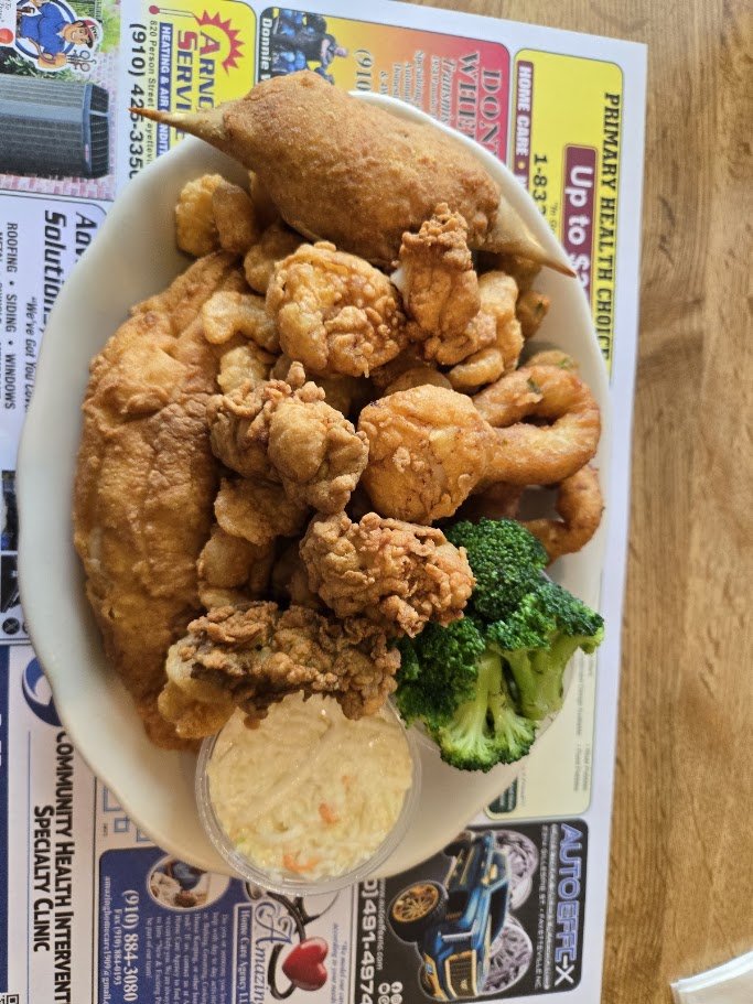 Plates of fried seafood on a simple table.